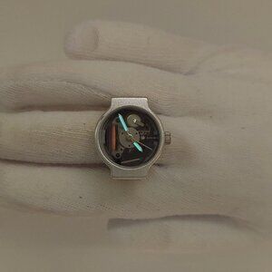 Vintage (transparent dial?) silver tone (2 glow hands) oval ring watch by migi (
